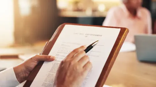 Signing a will on a clipboard